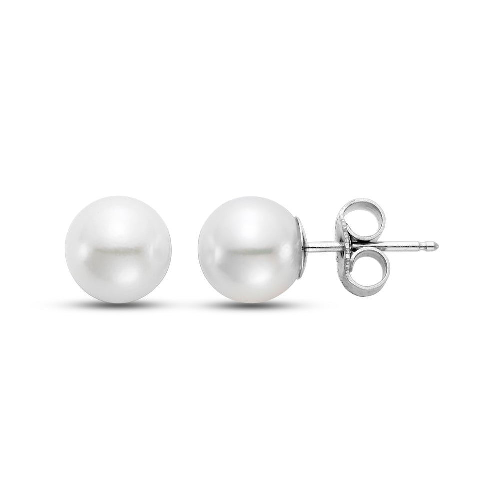 Two pearl earrings, one front side and the other on its side