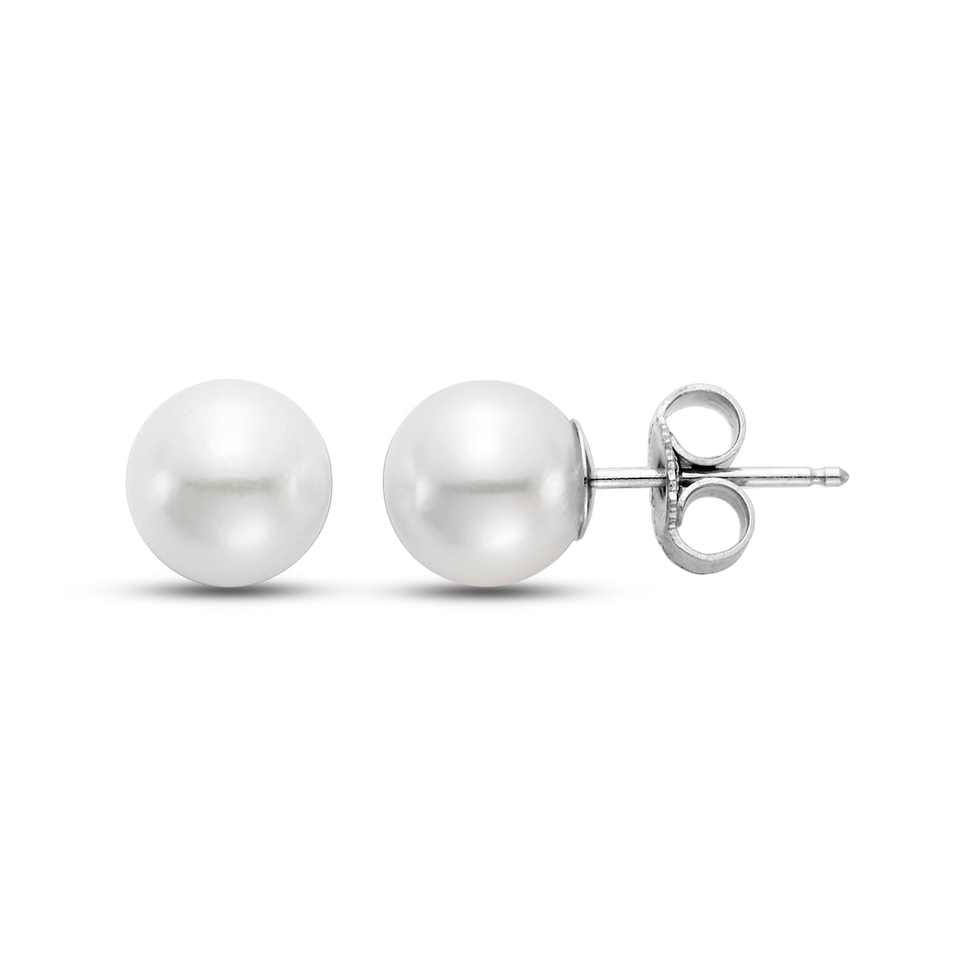Two pearl earrings, one front side and the other on its side
