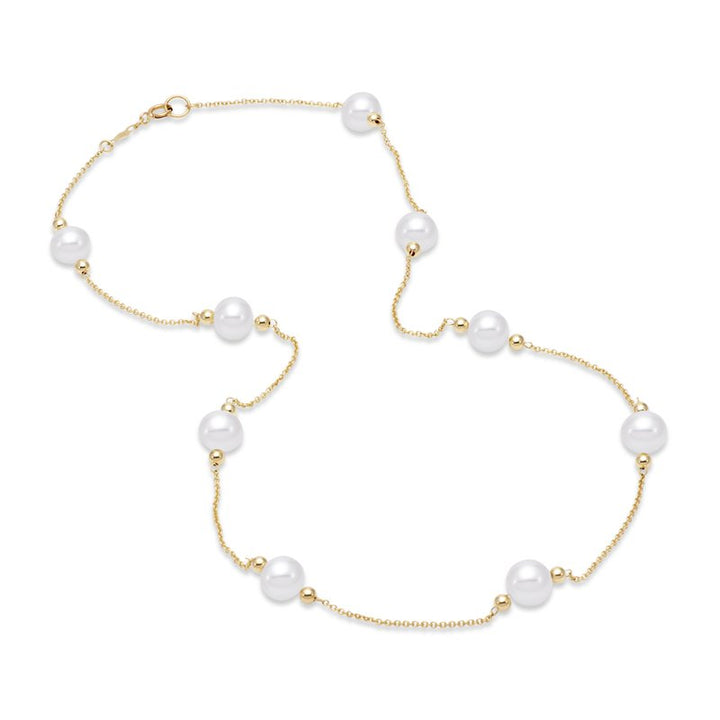 Gold necklace with pearls scattered around the gold chain