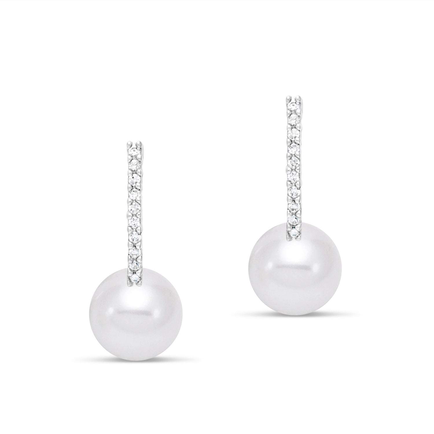Pair of pearl earrings hanging from diamonds