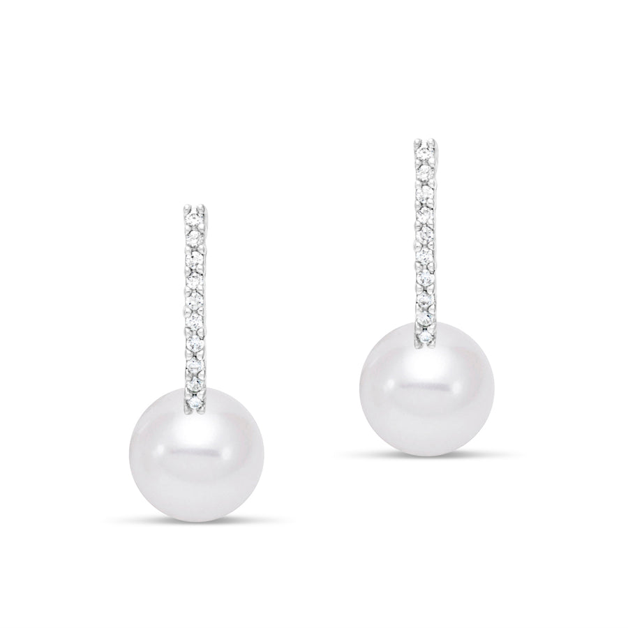 Pair of pearl earrings hanging from diamonds