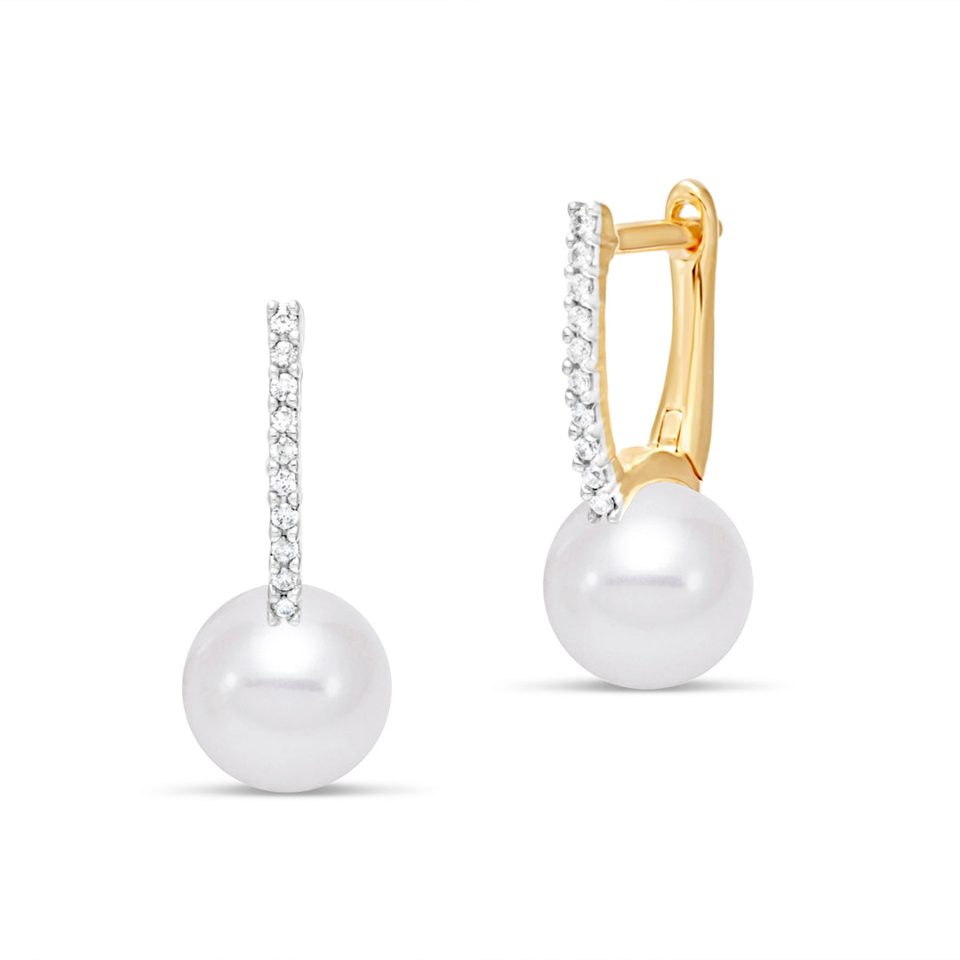 Pair of pearl earrings hanging from diamonds in a gold structure