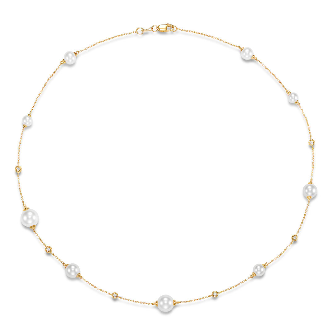 Gold necklace with pearls and diamonds scattered around the gold chain.