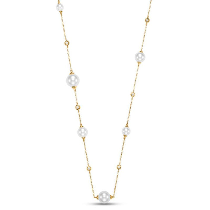 Gold necklace with pearls and diamonds scattered around the gold chain.