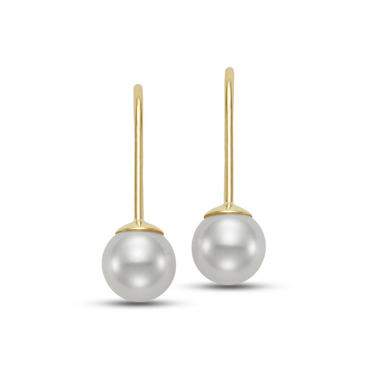 Pair of pearl earrings hanging from a gold hook