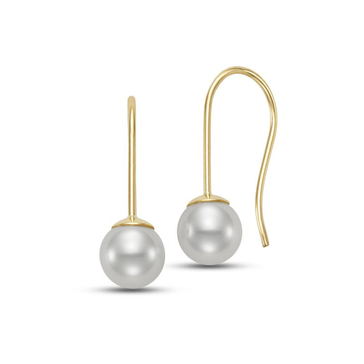 Pair of pearl earrings hanging from a gold hook