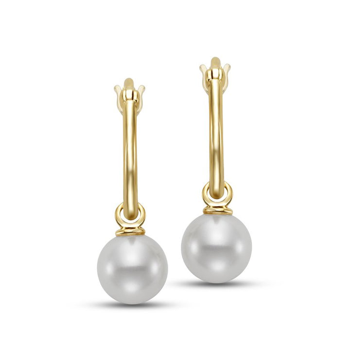 A pair of elegant gold hoop earrings each featuring a single white pearl drop suspended from a slim, polished gold hoop with a hinged closure.