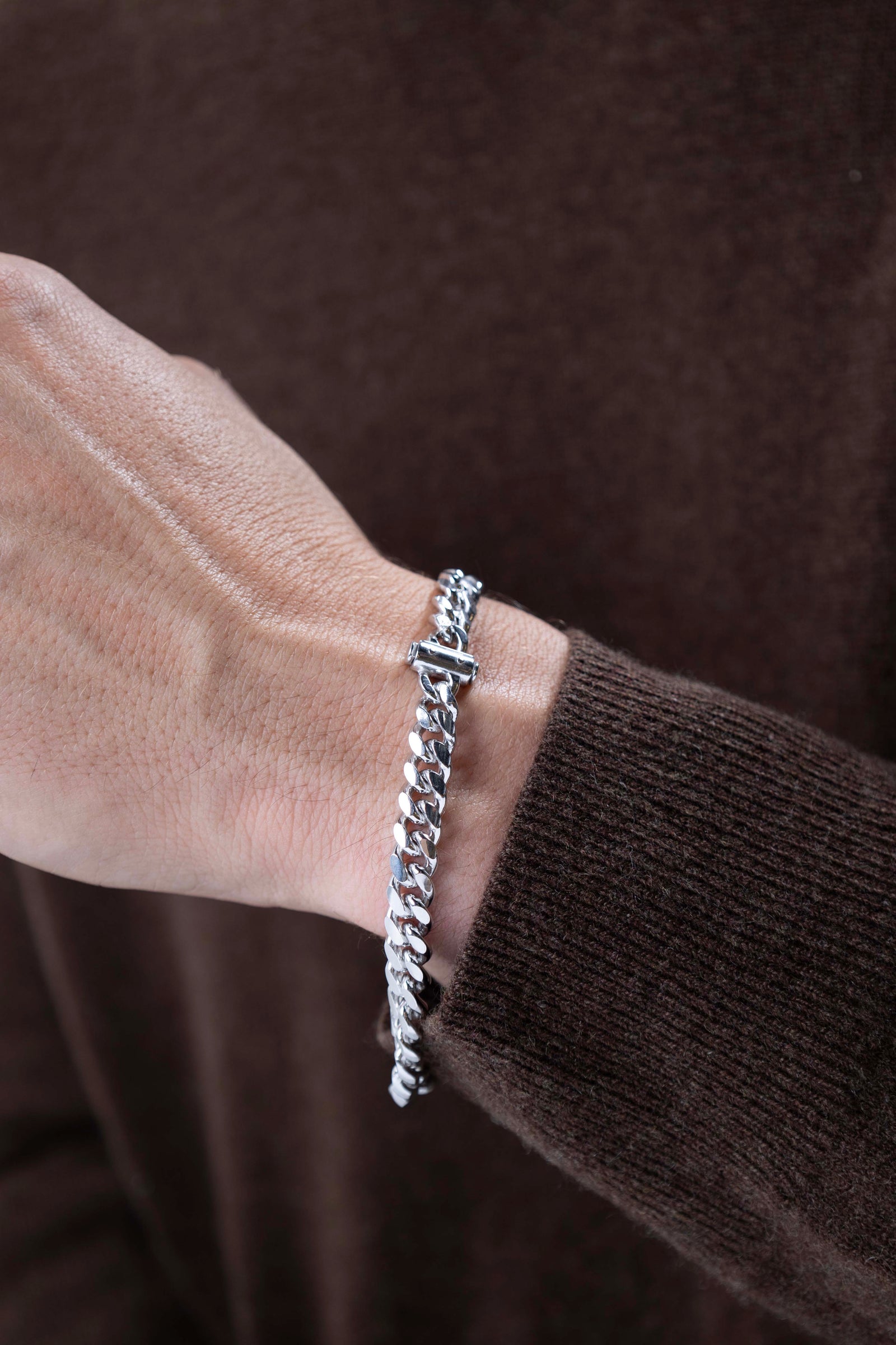 man wearing Italian Chain Rhodium Plated Oval Curb Bracelet with Push Lock - 8.5"