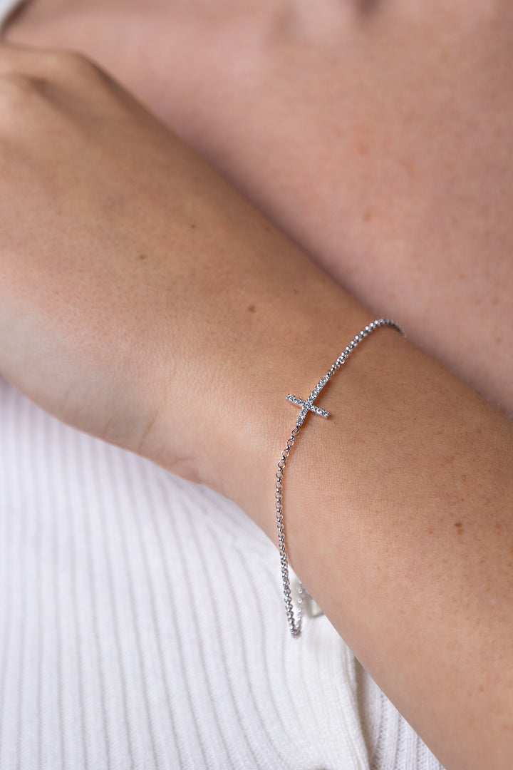 women wearing diamond-white-cross-bracelet