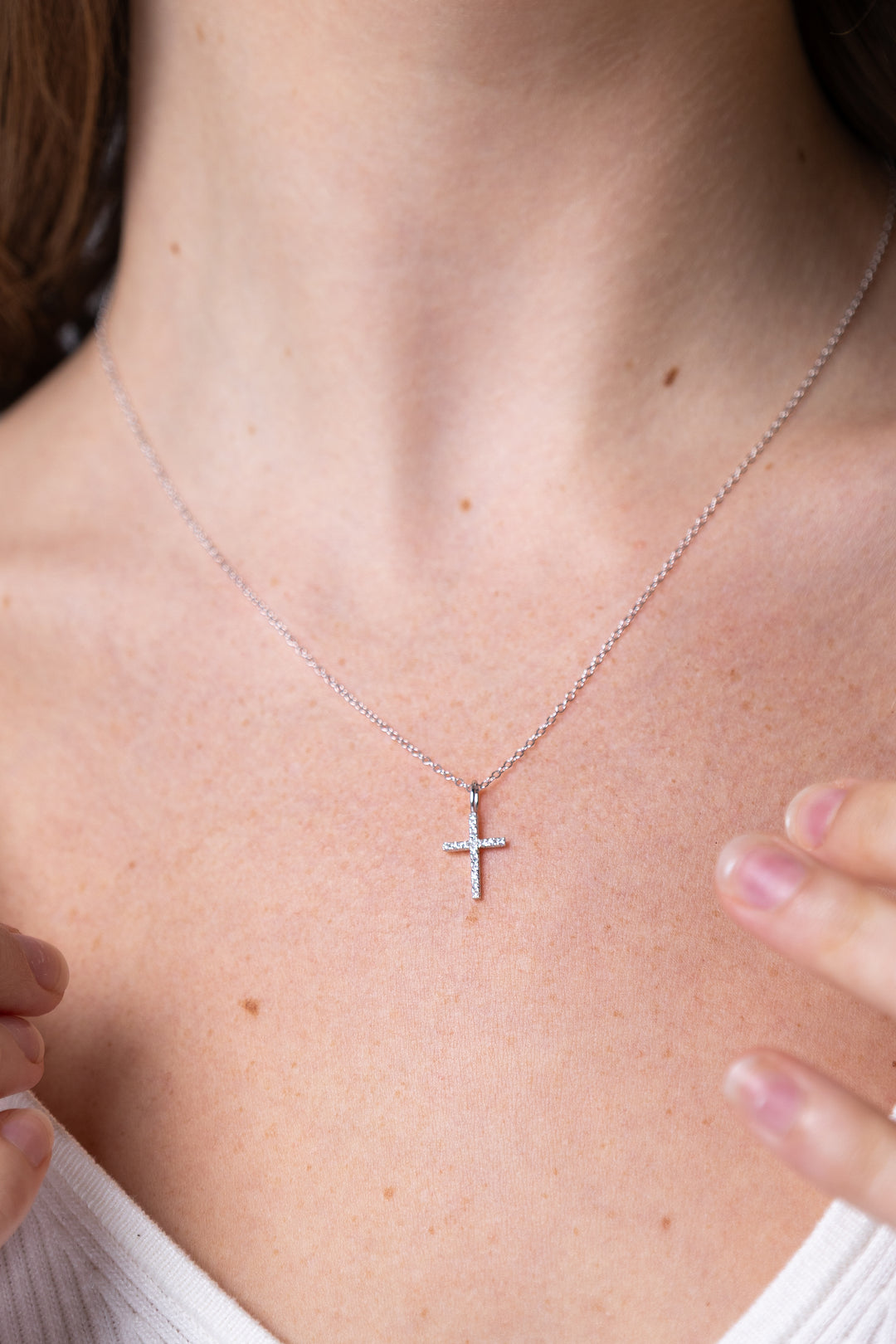 women wearing diamond-white-cross-necklace