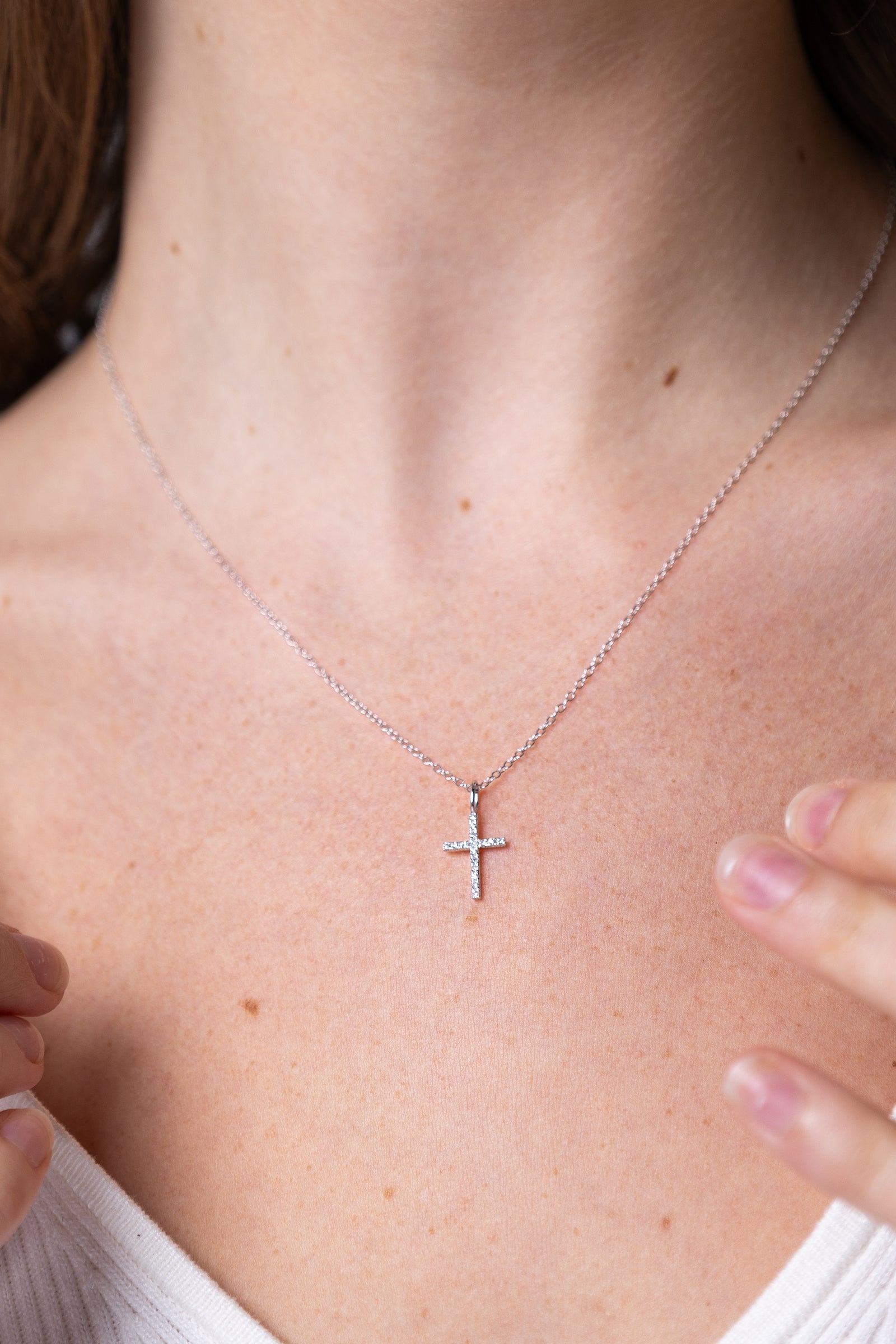 women wearing diamond-white-cross-necklace