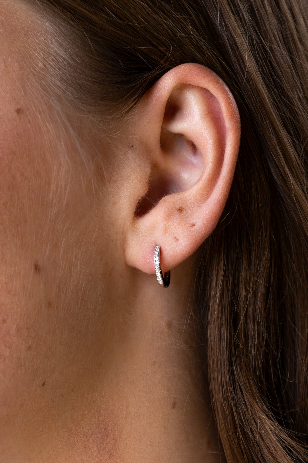 women wearing diamond-white-round-earrings
