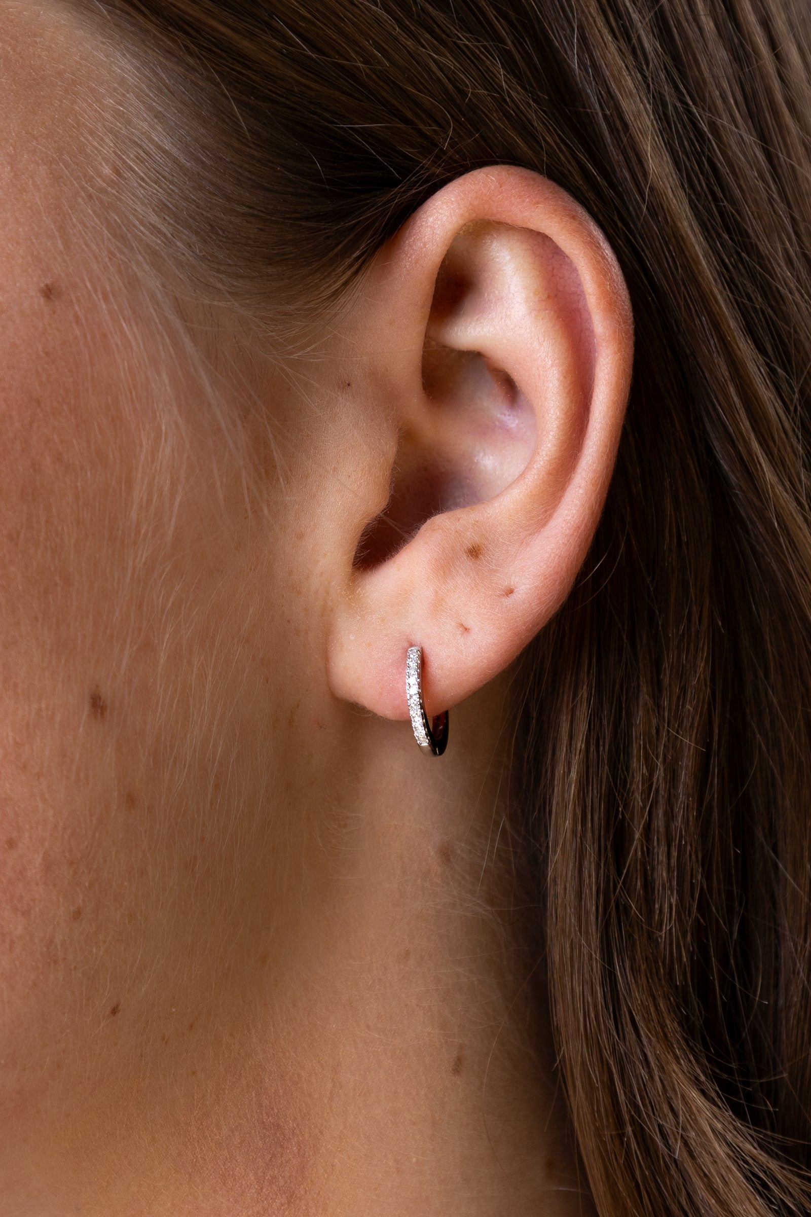 women wearing diamond-white-round-earrings