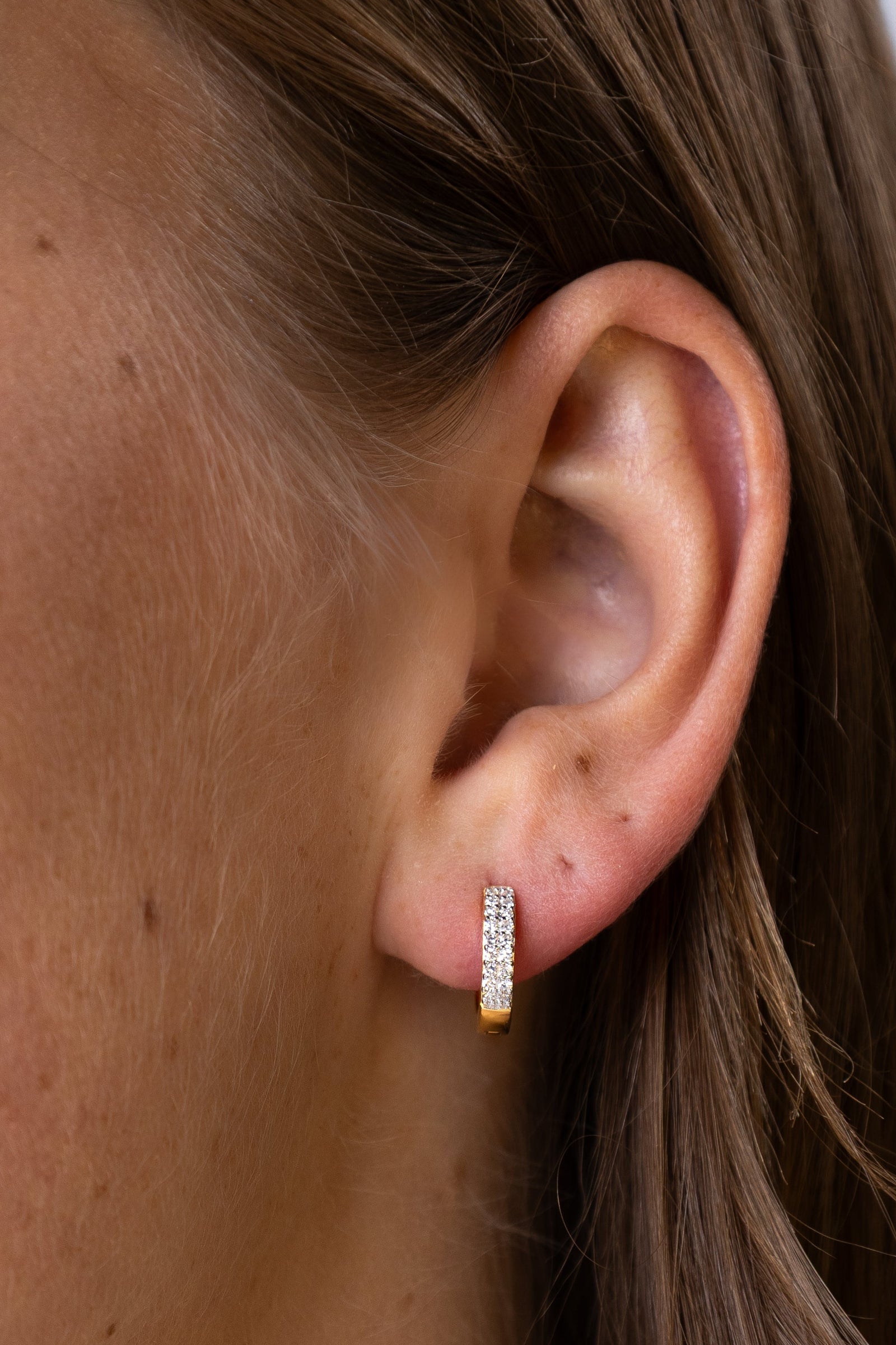 Women wearing Gold Double Row Hoop Earrings