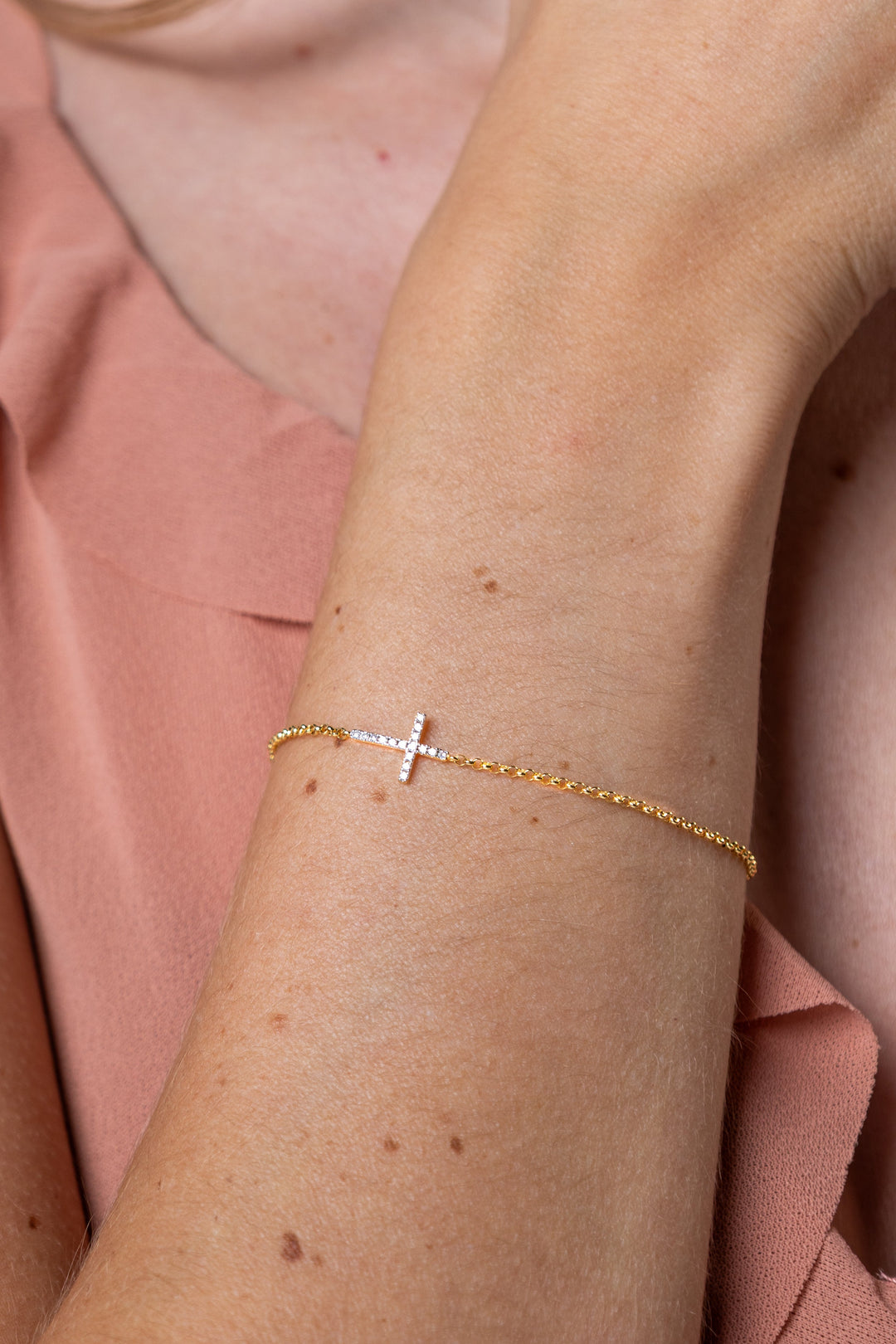 women wearing diamond-yellow-cross-bracelet