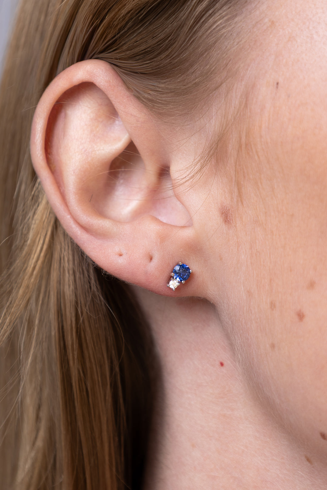 woman wearing silver-round-cut-lab-created-sapphire-diamond-accent-stud-earrings