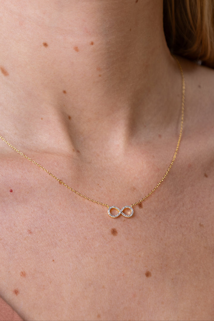 woman wearing diamond-yellow-infinity-necklace
