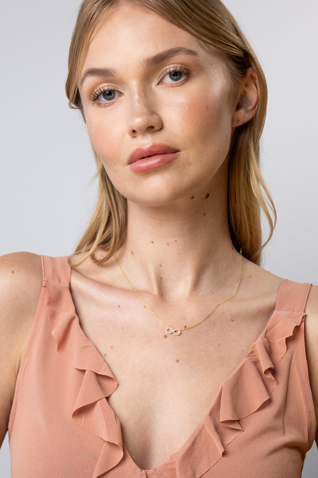 woman wearing diamond-yellow-infinity-necklace